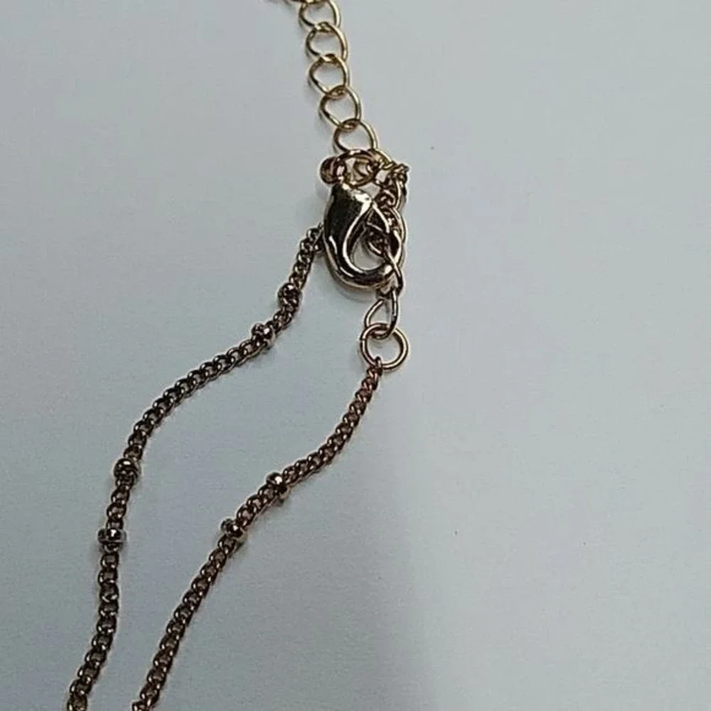 Snakeskin‎ circle pendant on goldtone chain